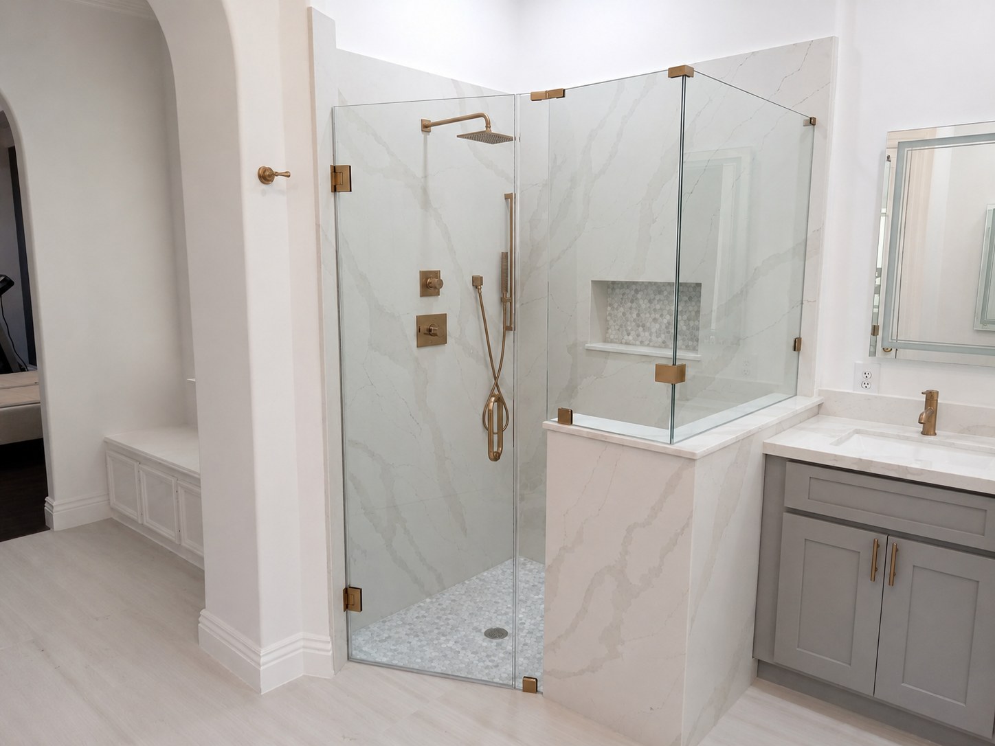 Completed bathroom renovation with glass shower and updated finishes