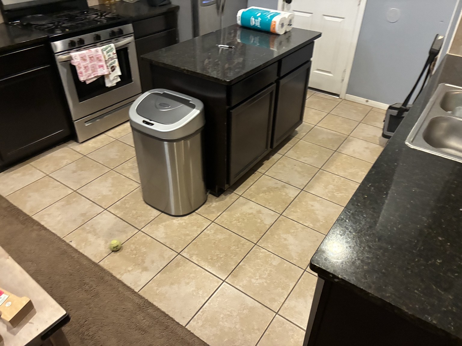 Kitchen before flooring replacement with the original square tile floor