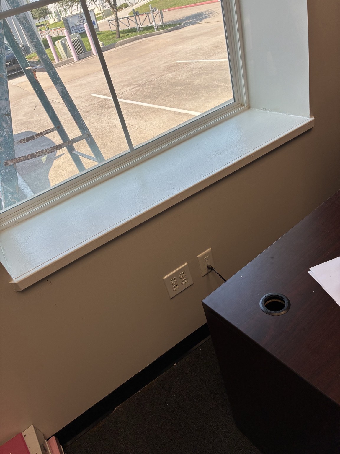 Commercial office window after sill repair, trim installation, finishing, and paint