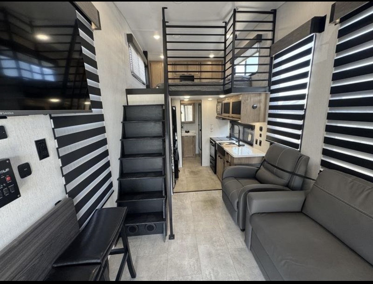 Timberwolf Mini Loft interior showing the living area, kitchen, staircase, loft, and bathroom entrance